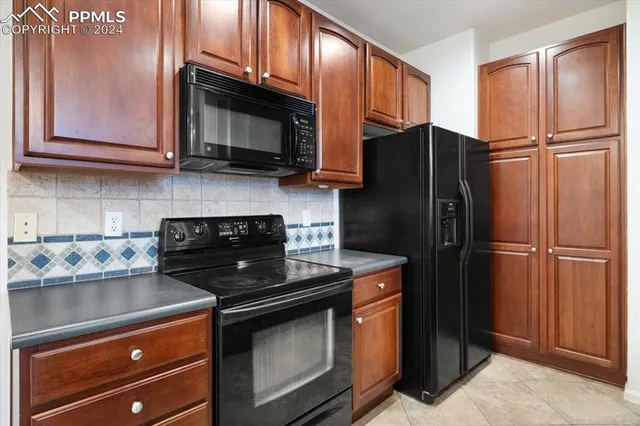 a kitchen with stainless steel appliances a sink stove and refrigerator