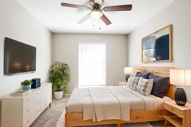 a bedroom with a large bed and a flat screen tv