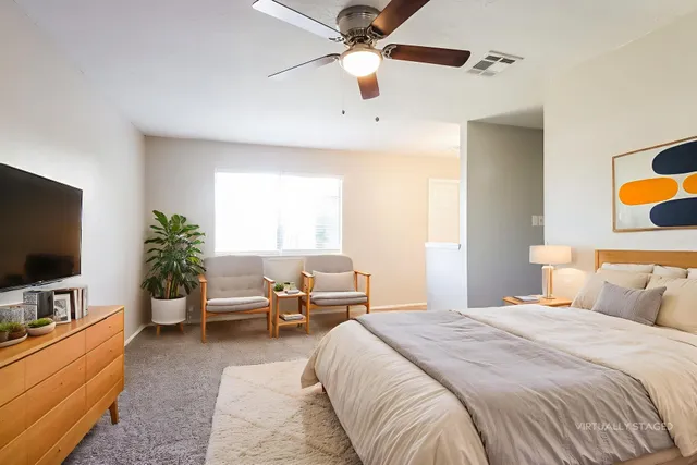 a bedroom with a bed and a flat screen tv