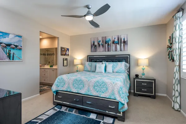 a bedroom with a bed and a chandelier