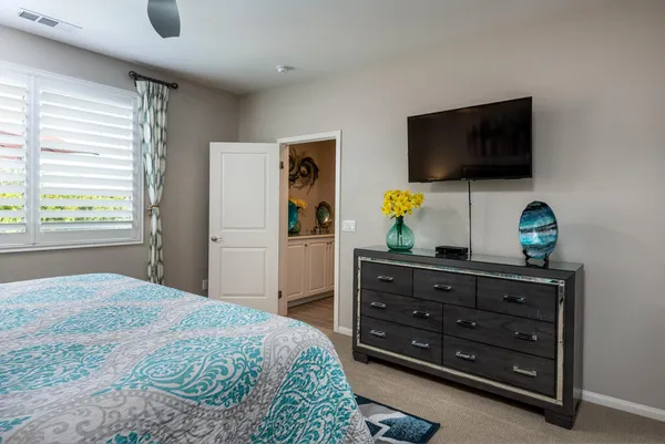 a bedroom with a bed and flat screen tv
