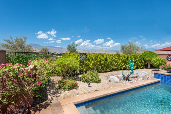 a view of a fountain in the backyard of the house