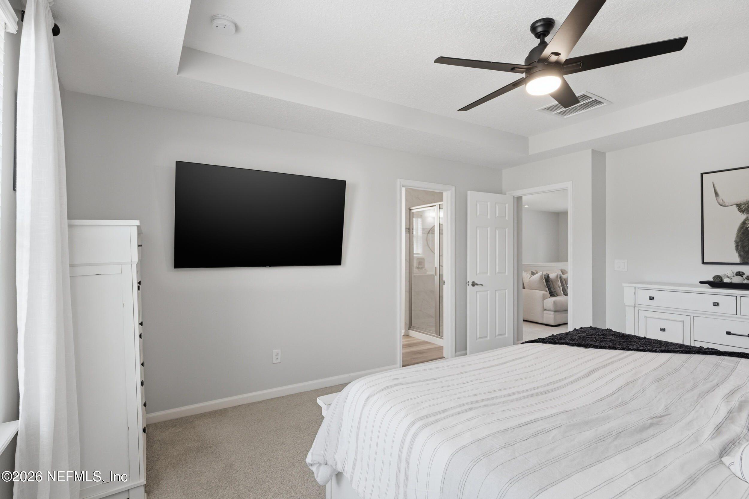 49 Oak Shadow Place St. Johns, FL 32259 - Photo 26 of 48 a bedroom with a bed and a flat screen tv