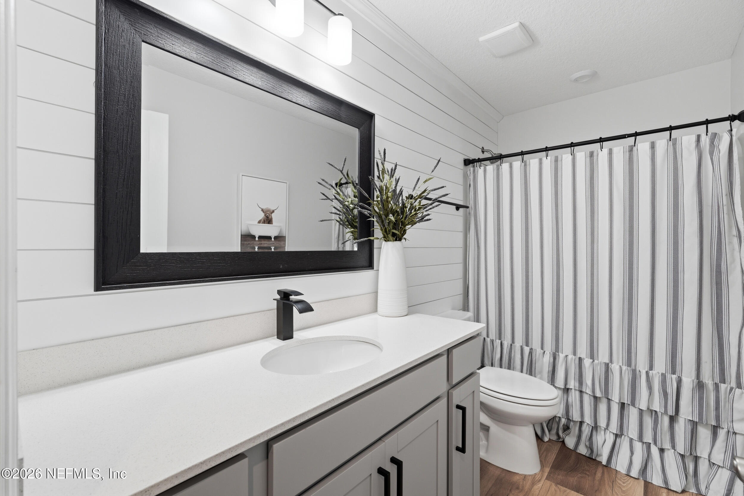 49 Oak Shadow Place St. Johns, FL 32259 - Photo 29 of 48 a bathroom with a toilet a sink and mirror