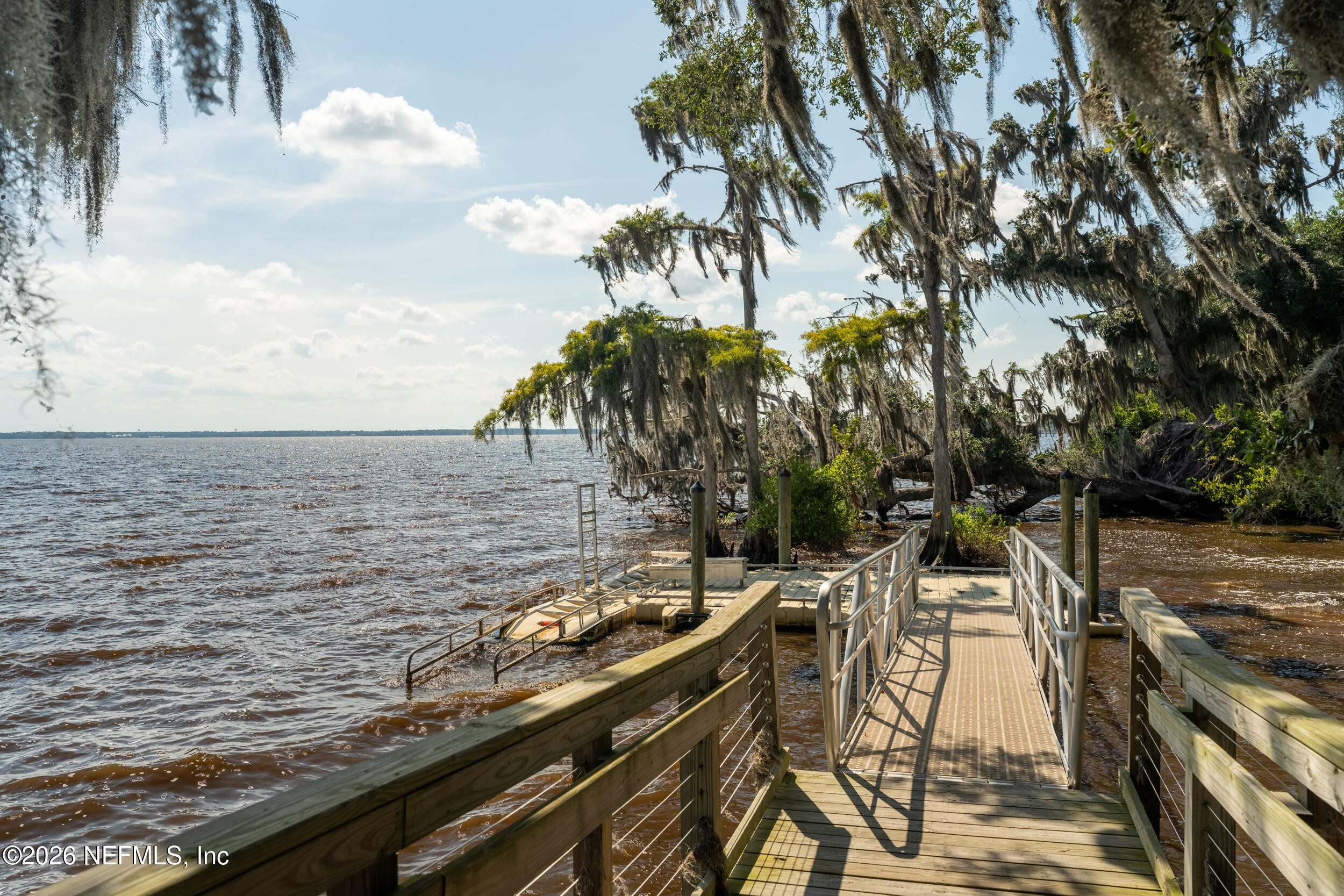 49 Oak Shadow Place St. Johns, FL 32259 - Photo 43 of 48 a view of a lake with a table and chairs