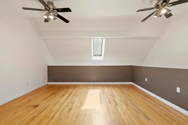 a view of a big room with wooden floor and windows in a room