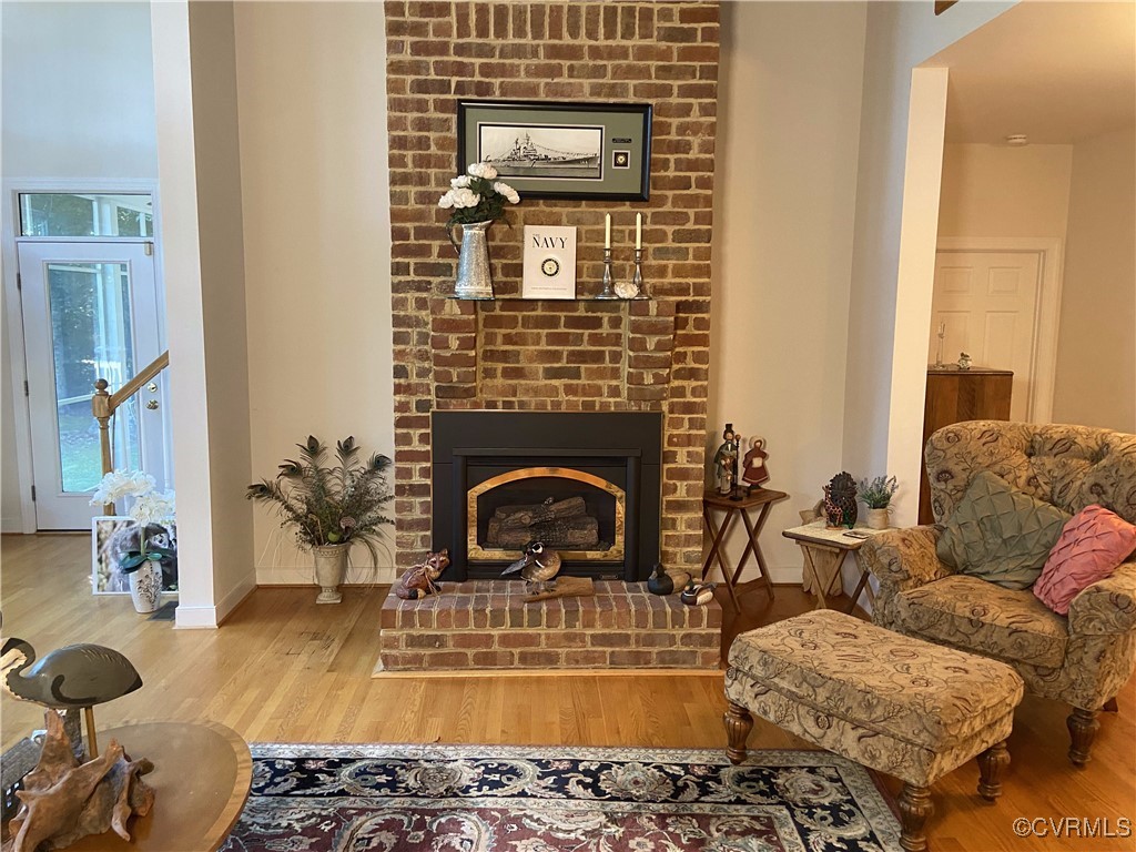 403 Woodruff Drive Aylett, VA 23009 - Photo 22 of 33 Living area with wood-type flooring and a brick fi
