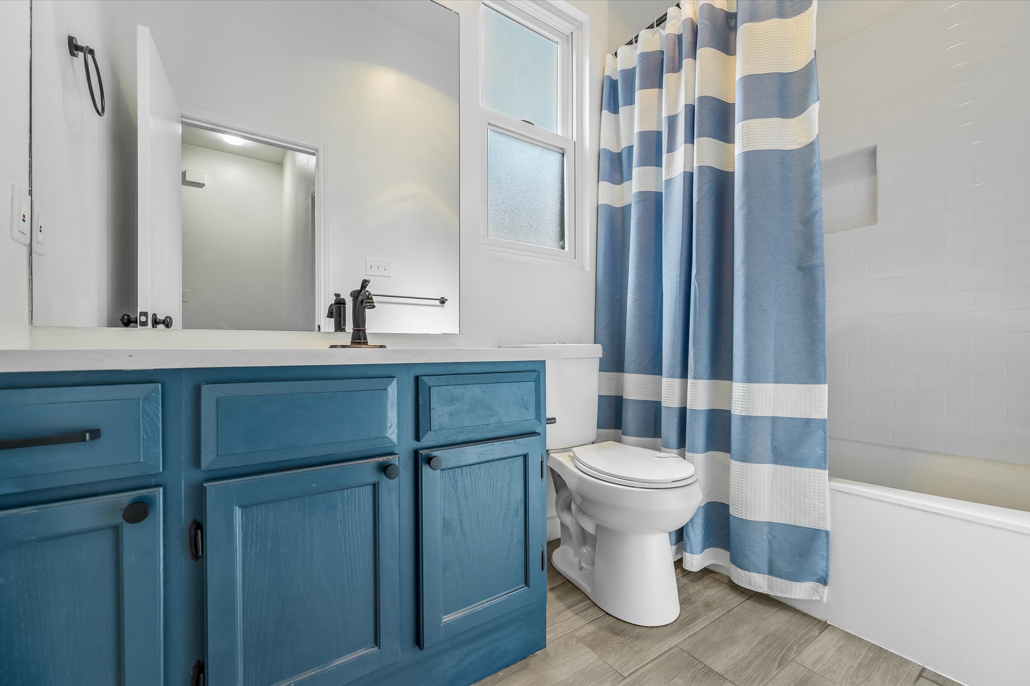 10203 Brantley Bend Austin, TX 78748 - Photo 15 of 20 Full bathroom featuring shower / bath combination with curtain, vanity, and wood tiled floors