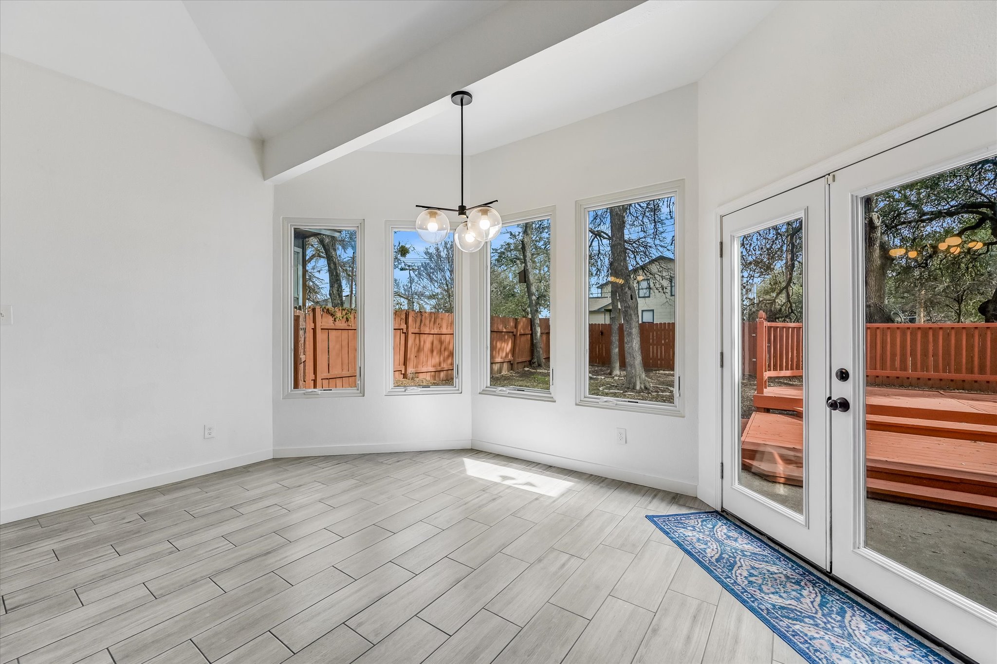 10203 Brantley Bend Austin, TX 78748 - Photo 6 of 20 Unfurnished sunroom with french doors, vaulted ceiling, and wood finish floors