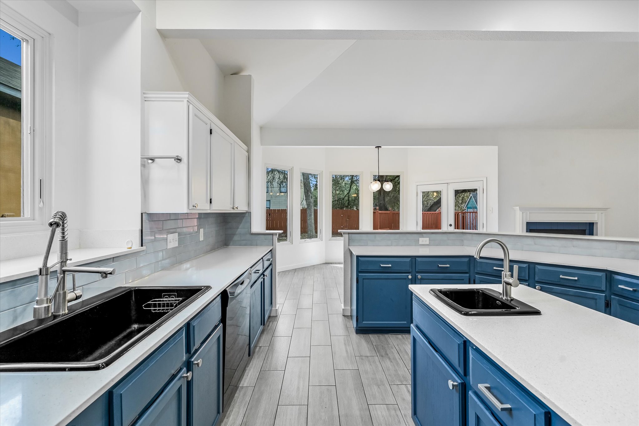 10203 Brantley Bend Austin, TX 78748 - Photo 9 of 20 Two tone kitchen with decorative light fixtures, two tone cabinets, dishwashing machine, light stone counters, and tasteful backsplash