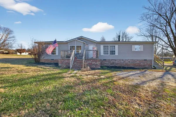 a view of a house with a yard and garage