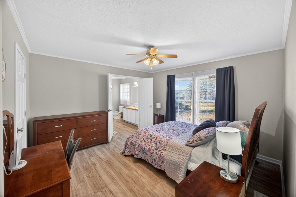 308 Allen's Chapel Road Smithville, TN 37166 - Photo 17 of 26 a bedroom with a bed and wooden floor