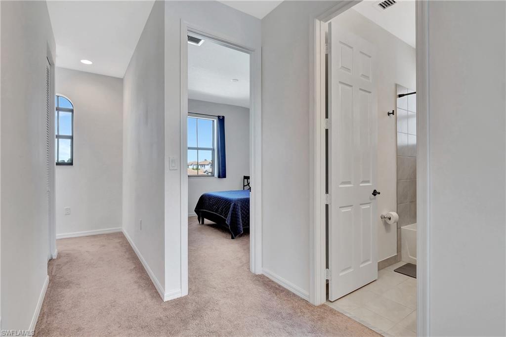 9041 Madrid Circle Naples, FL 34104 - Photo 14 of 32 a view of a bedroom from a hallway