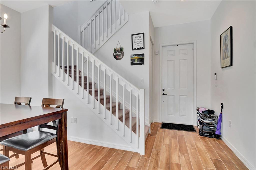 9041 Madrid Circle Naples, FL 34104 - Photo 18 of 32 a view of entryway and hall with wooden floor