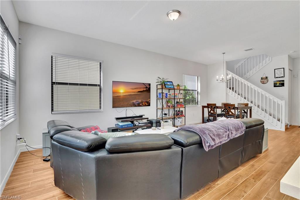 9041 Madrid Circle Naples, FL 34104 - Photo 22 of 32 a living room with furniture and a flat screen tv