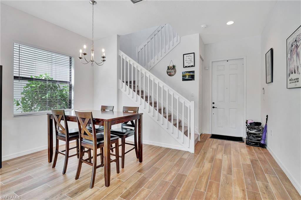 9041 Madrid Circle Naples, FL 34104 - Photo 29 of 32 a view of a dining room with furniture window and wooden floor