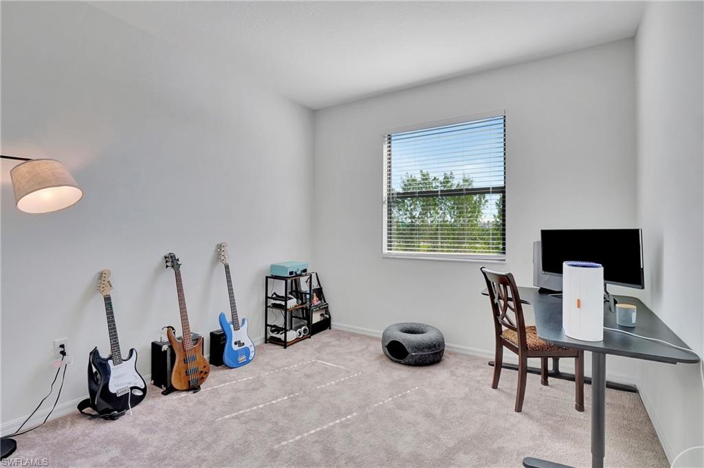 9041 Madrid Circle Naples, FL 34104 - Photo 7 of 32 a view of a workspace with furniture and a window