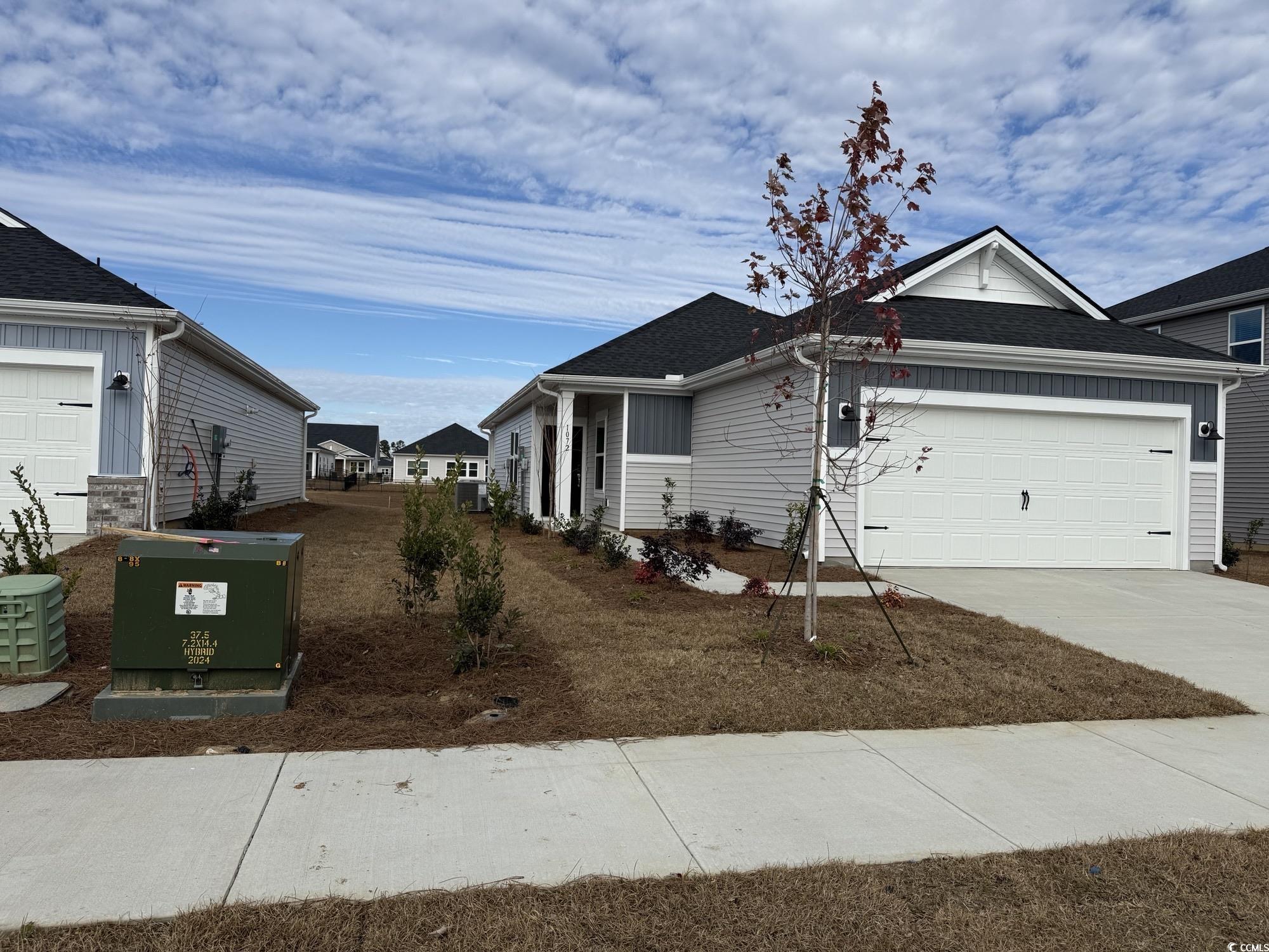 1072 Lauryn Oak Loop Longs, SC 29568 - Photo 2 of 4 Single story home with concrete driveway, an attached garage, and a shingled roof