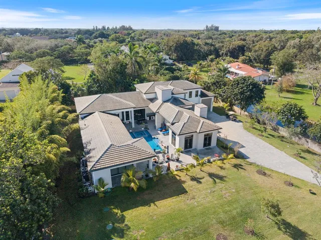 an aerial view of a house with a yard