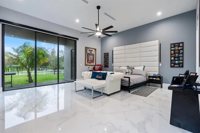 a bedroom with a bed and ceiling fan