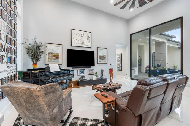 a living room with furniture and a floor to ceiling window