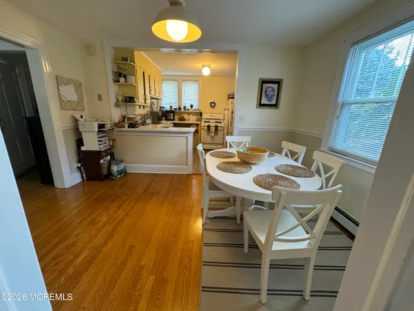a kitchen with a sink chairs and cabinets