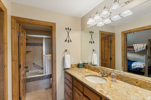 755 South Zion Ridge Drive Orderville, UT 84758 - Photo 61 of 84 Ensuite bathroom featuring vanity, tiled shower / bath combo, and light tile patterned floors