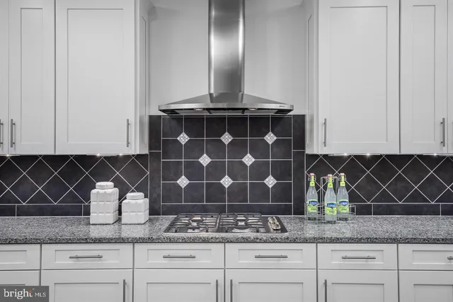 a bathroom with a granite countertop double vanity sink