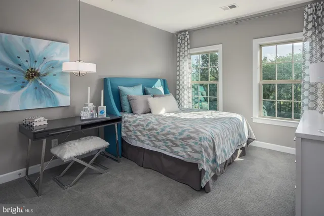 a bedroom with a bed chair and window