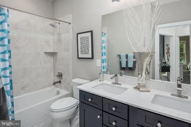 a bathroom with a sink double vanity granite toilet tub and shower