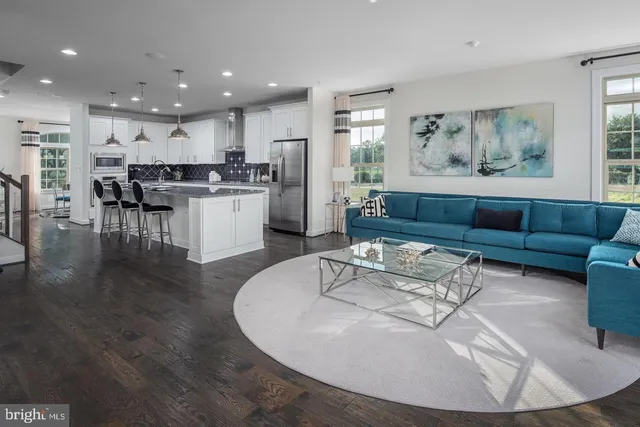 a living room with furniture and kitchen view