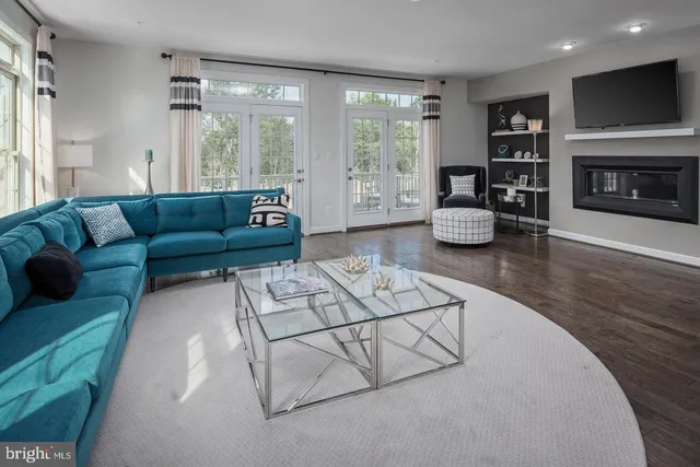 a living room with furniture fireplace and flat screen tv