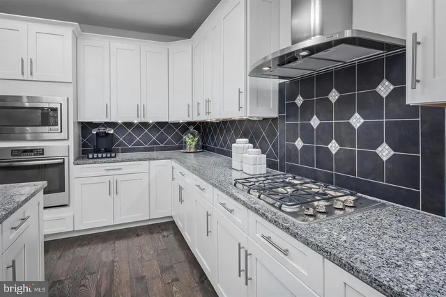 a kitchen with a sink a stove and cabinets
