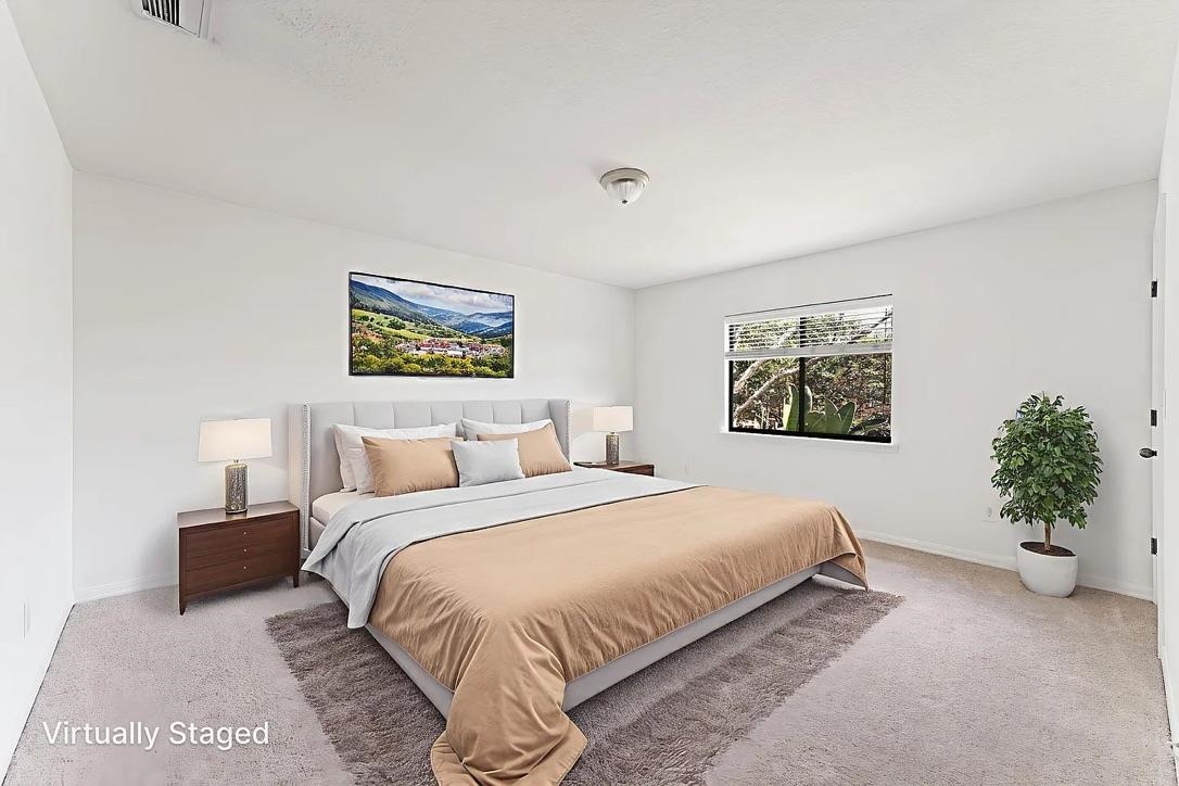 308 Syrah Way St. Augustine, FL 32084 - Photo 13 of 24 a bedroom with a bed and a painting on the wall