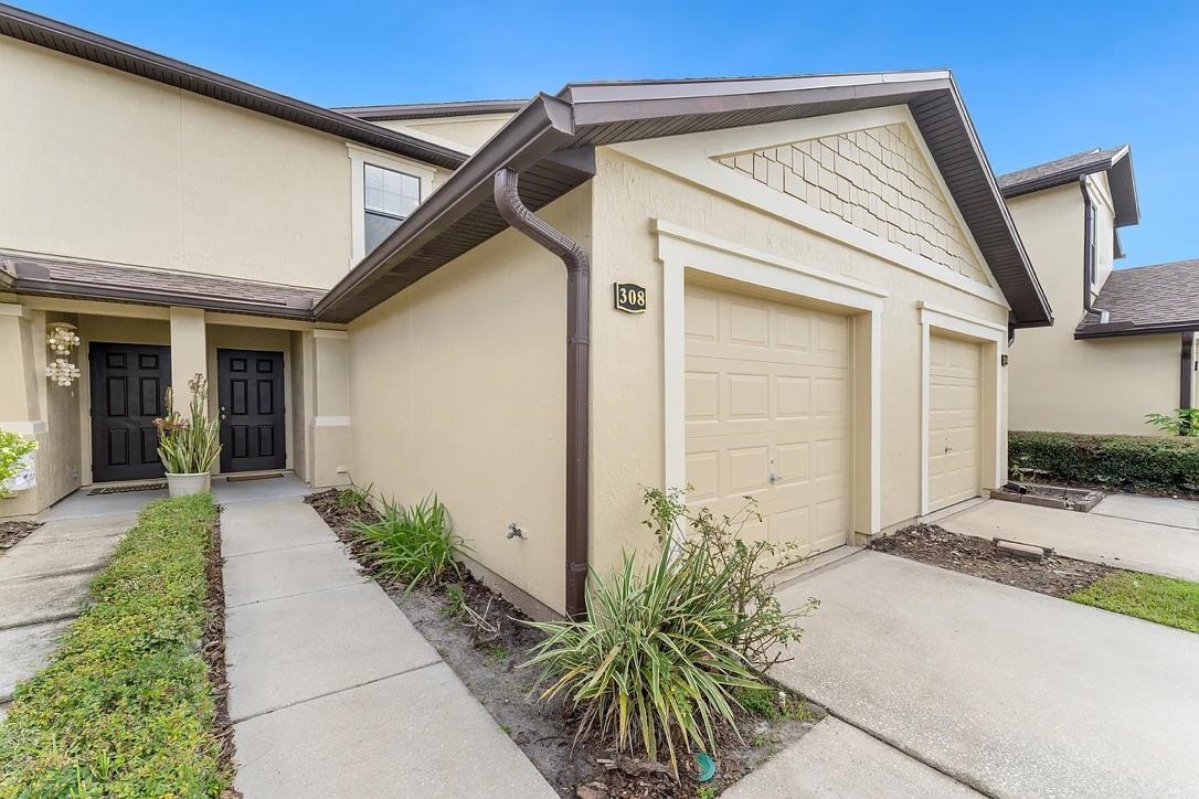 308 Syrah Way St. Augustine, FL 32084 - Photo 3 of 24 a front view of a house with a yard