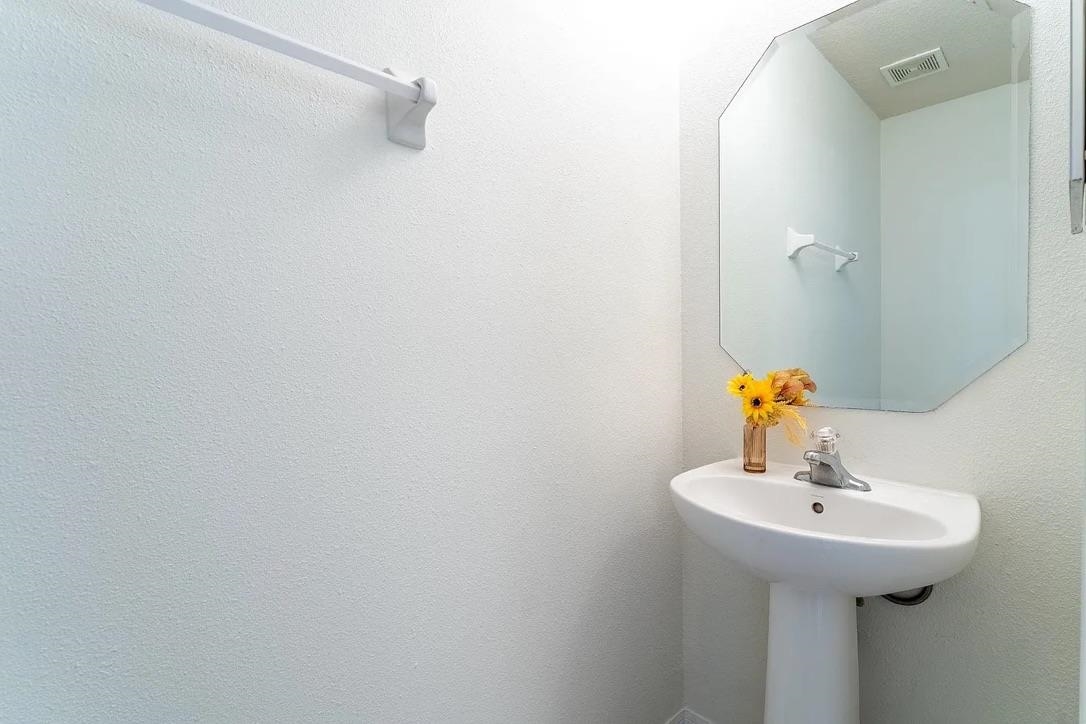 308 Syrah Way St. Augustine, FL 32084 - Photo 7 of 24 a bathroom with a sink and mirror