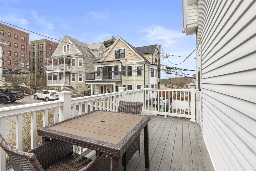 55 Main Street Somerville, MA 02145 - Photo 15 of 28 a view of a house with a wooden deck