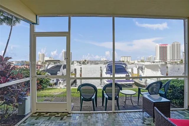 a view of a balcony with furniture and city view