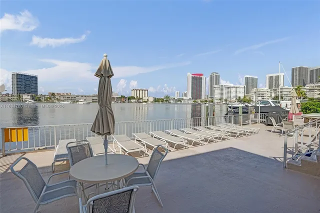 a view of roof deck with two chair and a fireplace