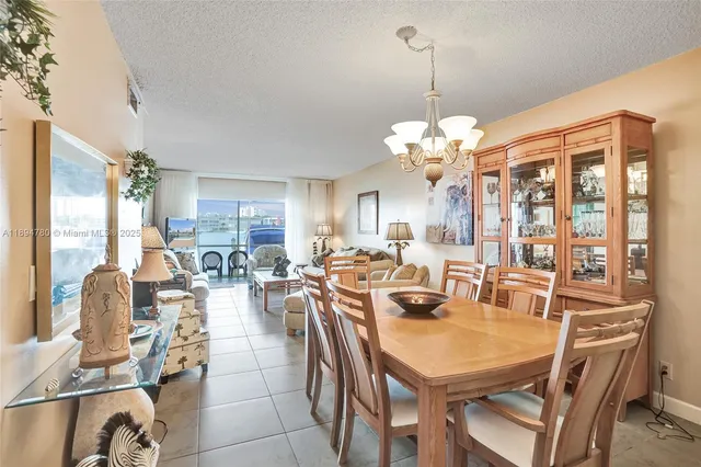 a view of a dining room with furniture a chandelier and wooden floor