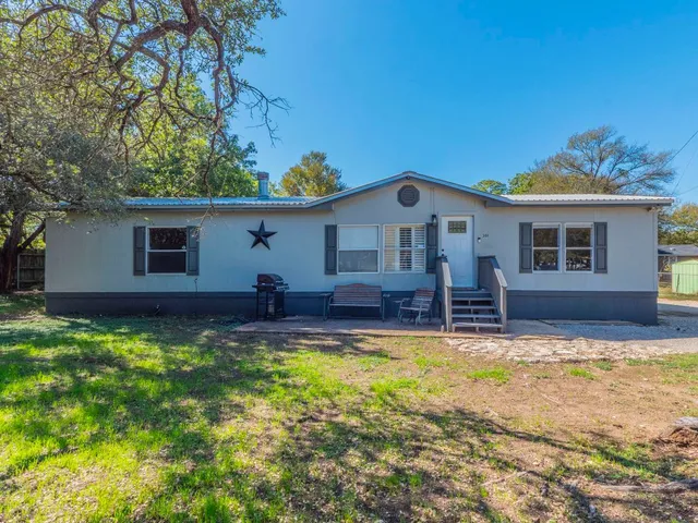 a view of a house with swimming pool and sitting area