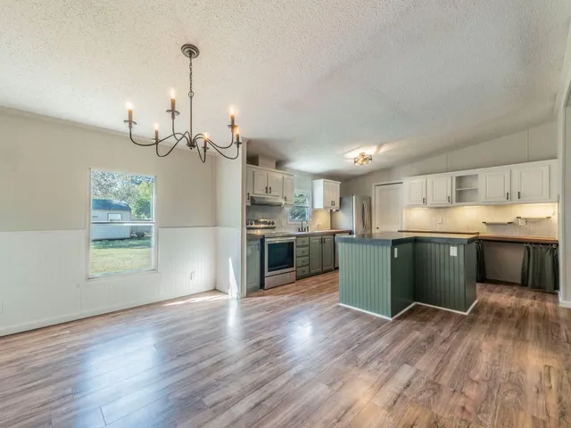 a view of a kitchen with a sink wooden floor and a kitchen