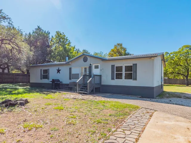 a view of a house with swimming pool and a yard