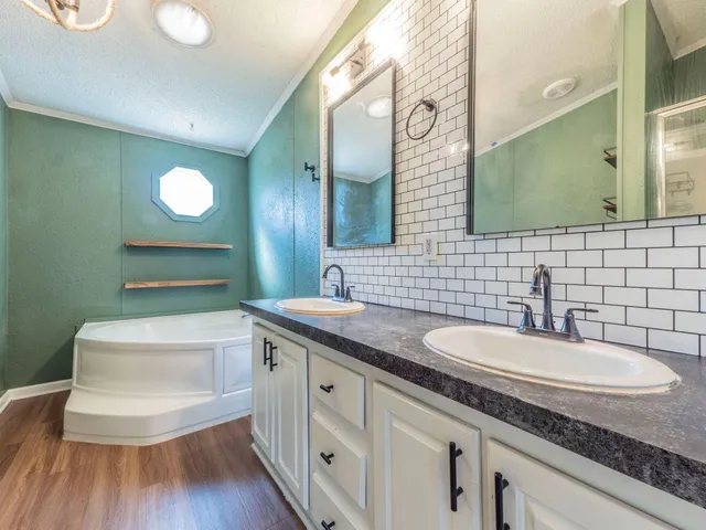 a bathroom with a granite countertop sink a toilet and a mirror