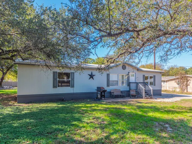 a front view of house with yard and outdoor seating