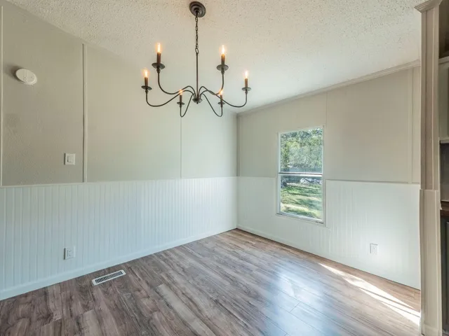a view of a room with an empty space and a window