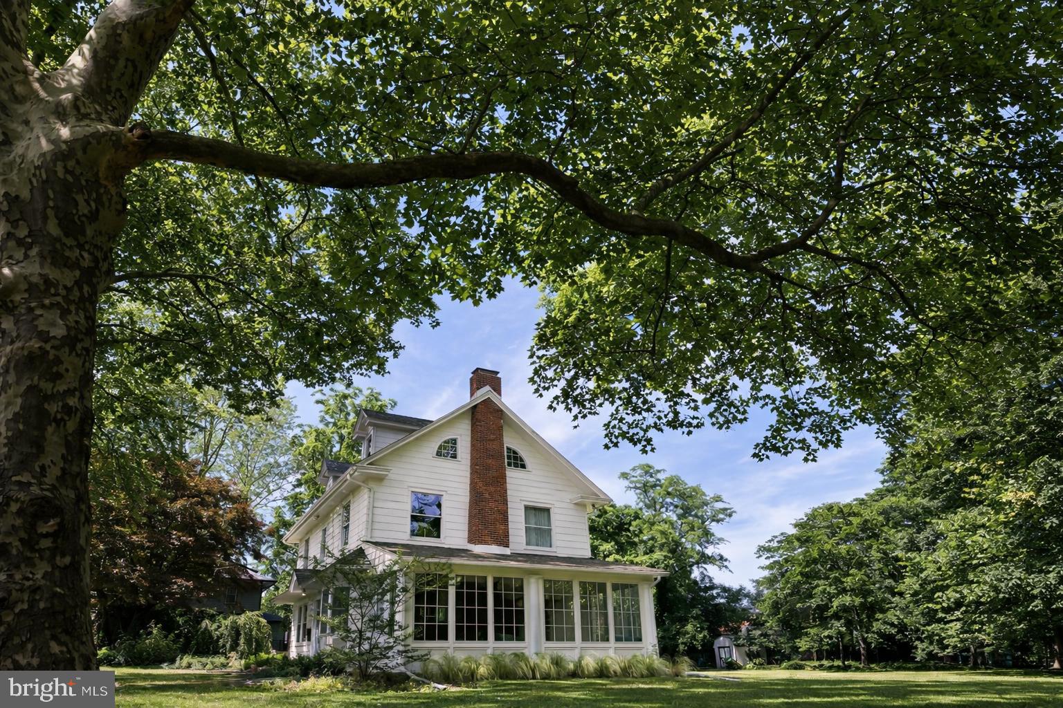 a yellow house with trees in front of it