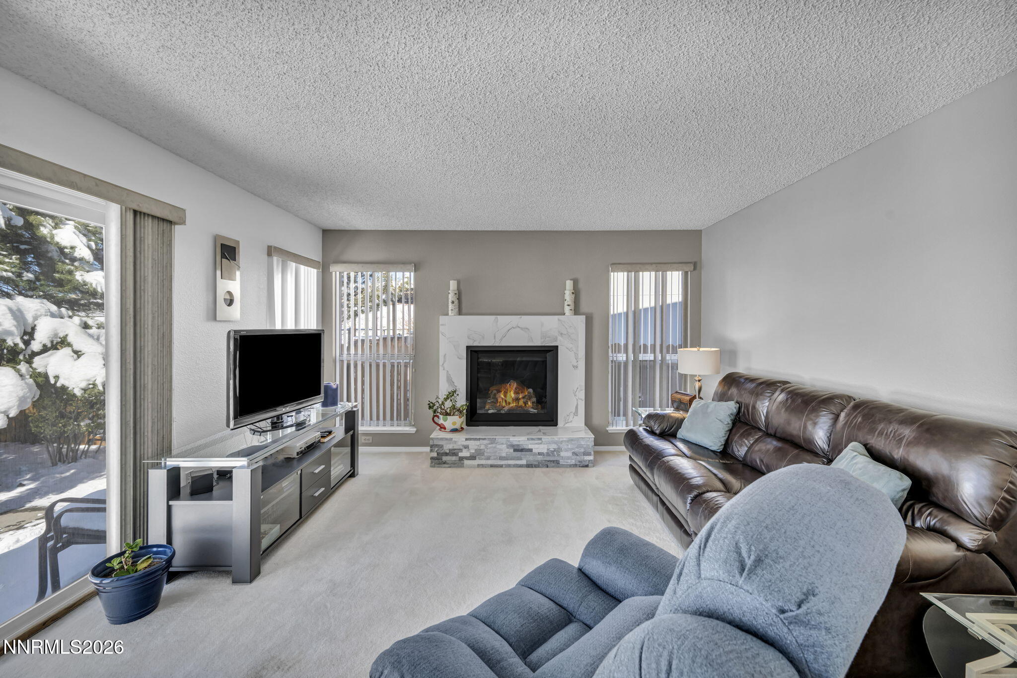 4692 Canyon Ridge Lane Reno, NV 89523 - Photo 28 of 68 a living room with furniture a flat screen tv and a fireplace