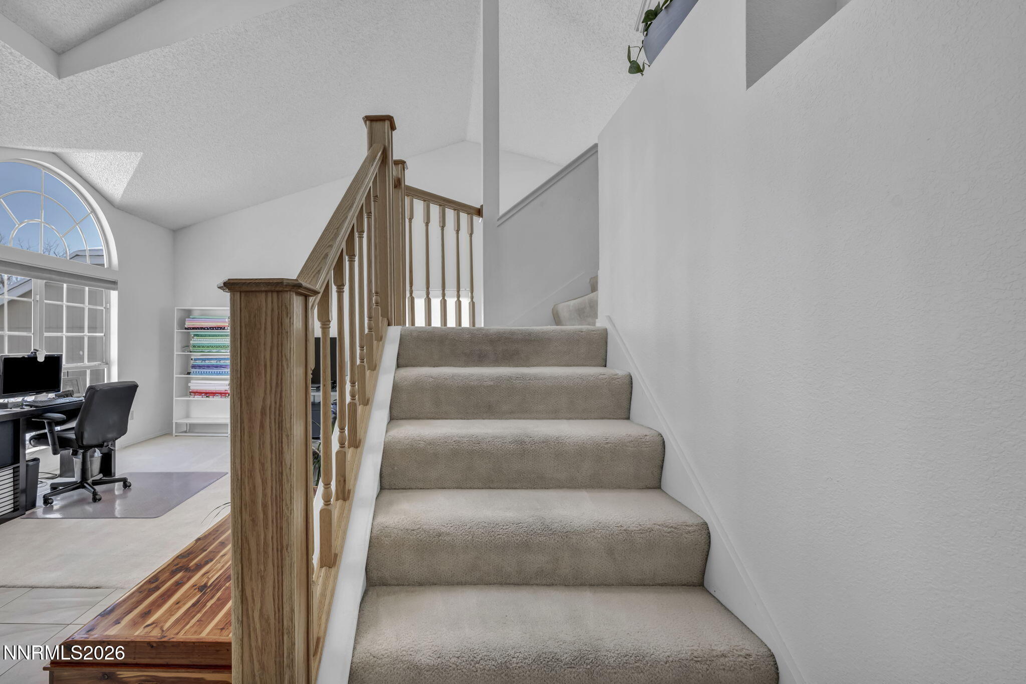 4692 Canyon Ridge Lane Reno, NV 89523 - Photo 31 of 68 a view of staircase with lots of frames on wall and a rug