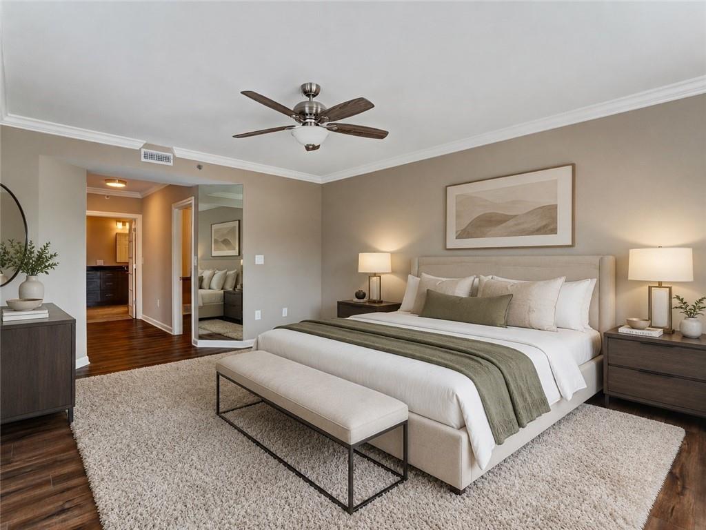 3435 Kingsboro Road Northeast, Unit 1601 Atlanta, GA 30326 - Photo 23 of 54 a spacious bedroom with a bed a couch and potted plant on the dresser